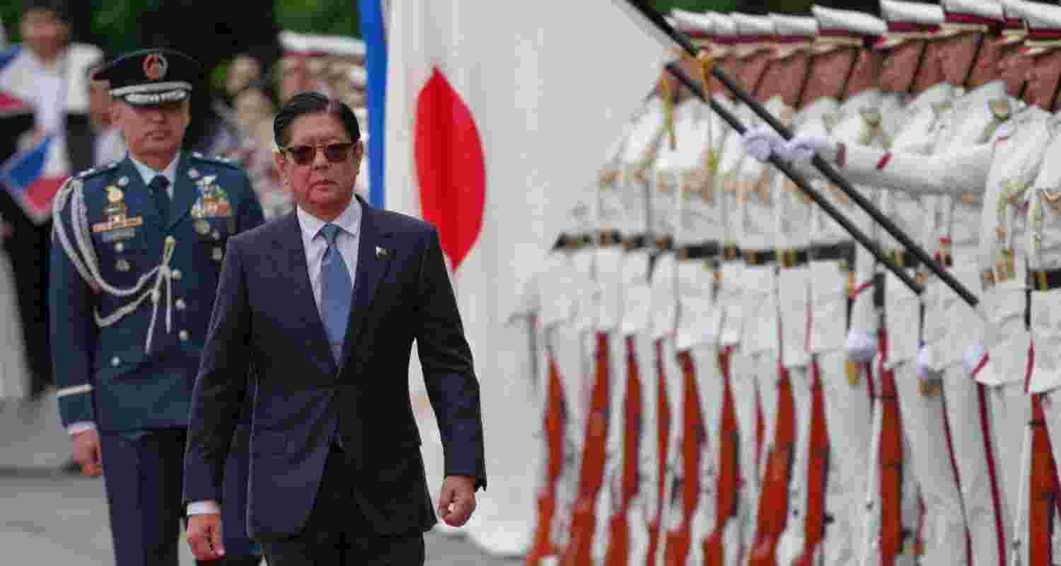 Philippine President Ferdinand Marcos being received with a ceremonial guard of honour at the Inperial Palace in Tokyo.