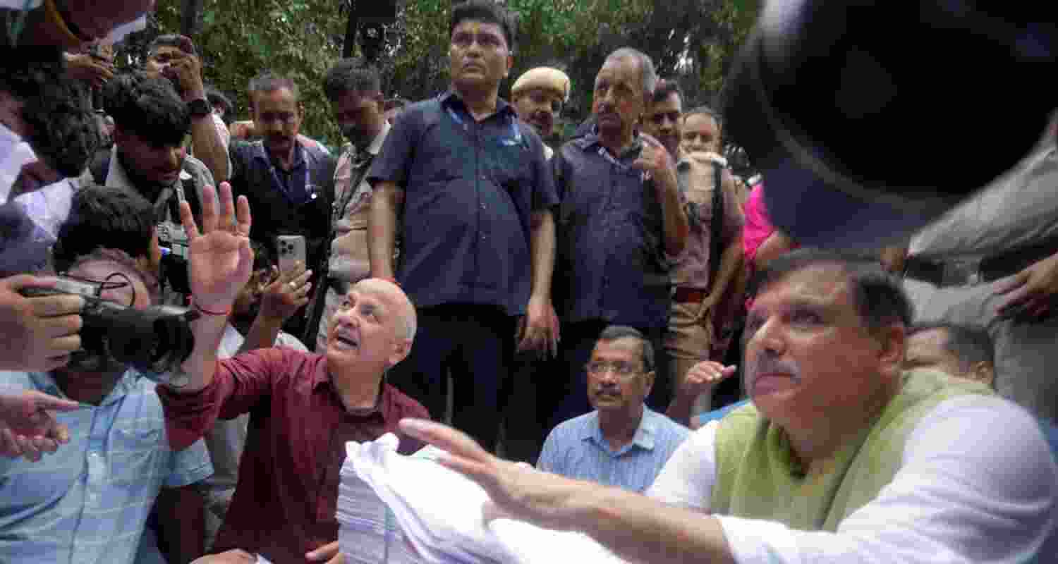 Former Delhi chief minister and AAP chief Arvind Kejriwal, party leaders Sanjay Singh and Manish Sisodia and others sit on Firoz Shah Road after being stopped by the police during their protest march towards the Prime Minister's residence in New Delhi on Tuesday.