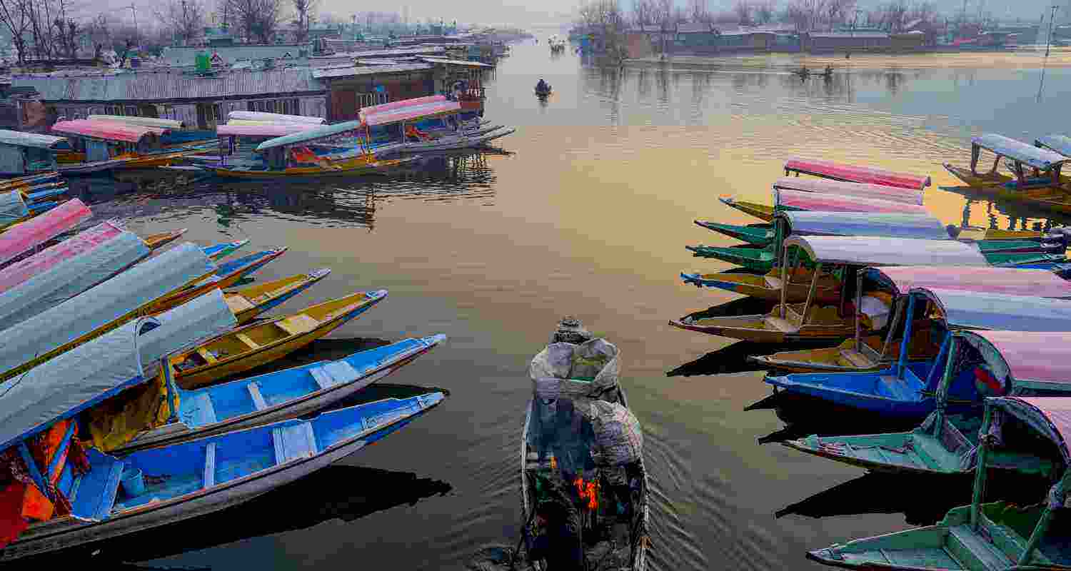 Workers light a bonfire on their boats to keep warm as the mercury plunges to minus 5.7 degrees Celsius during Chillai Kalan, the 40-day period of the harshest winter in the Kashmir Valley, at interior Dal Lake, in Srinagar, Saturday Workers light a bonfire on their boats to keep warm as the mercury plunges to minus 5.7 degrees Celsius during Chillai Kalan, the 40-day period of the harshest winter in the Kashmir Valley, at interior Dal Lake, in Srinagar, Saturday