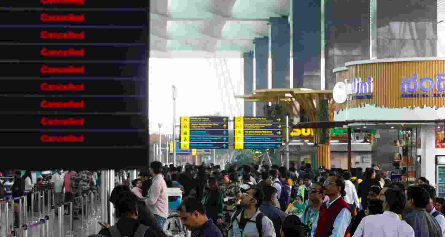 Stranded passengers wait at the airport amid widespread Indigo flights disruptions. Stranded passengers wait at the airport amid widespread Indigo flights disruptions.