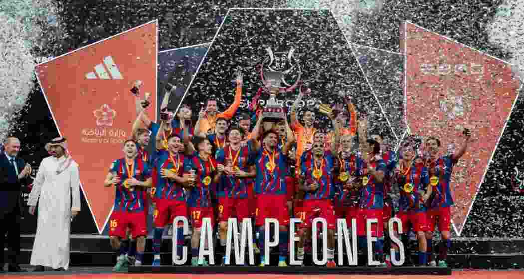 Barcelona players celebrate with the Spanish Super Cup trophy in Jeddah after defeating Real Madrid 3-2. Barcelona players celebrate with the Spanish Super Cup trophy in Jeddah after defeating Real Madrid 3-2.