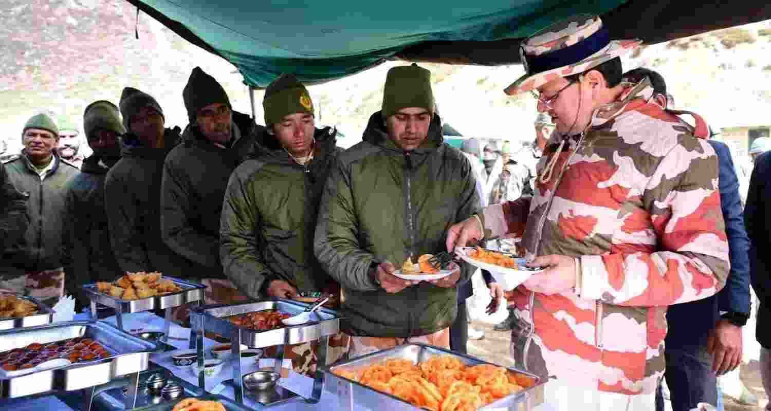 Chief Minister Pushkar Singh Dhami serves jalebi to ITBP jawans at Milam border camp, sharing light moments during his visit. Chief Minister Pushkar Singh Dhami serves jalebi to ITBP jawans at Milam border camp, sharing light moments during his visit.