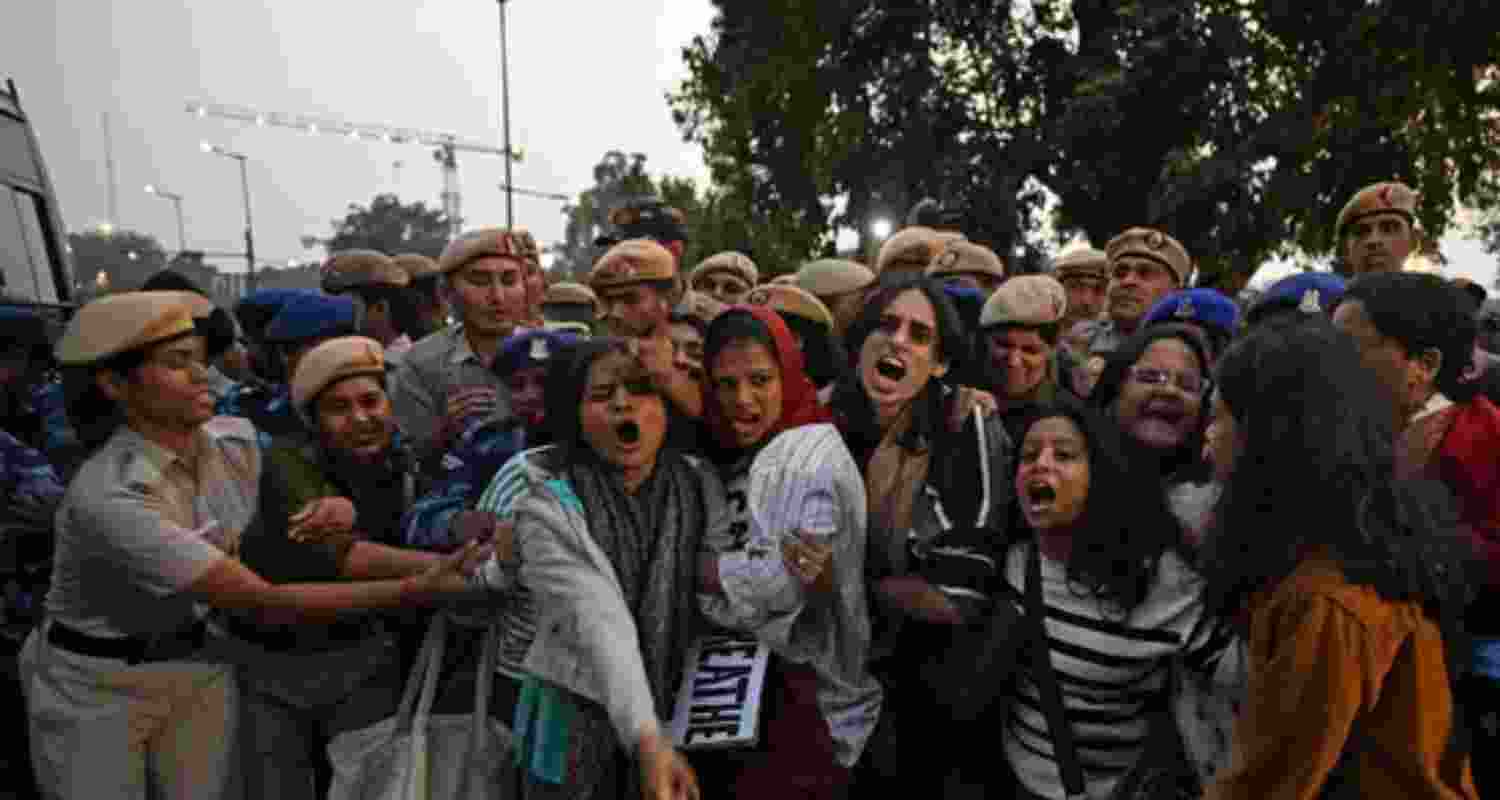 Police personnel detain demonstrators during a protest demanding the government take action to reduce air pollution near India Gate in New Delhi. Police personnel detain demonstrators during a protest demanding the government take action to reduce air pollution near India Gate in New Delhi.