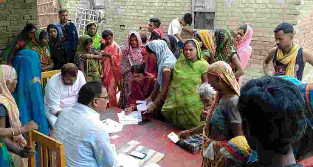 Election officials collect enumeration forms during the Special Intensive Revision of electoral rolls. Election officials collect enumeration forms during the Special Intensive Revision of electoral rolls.