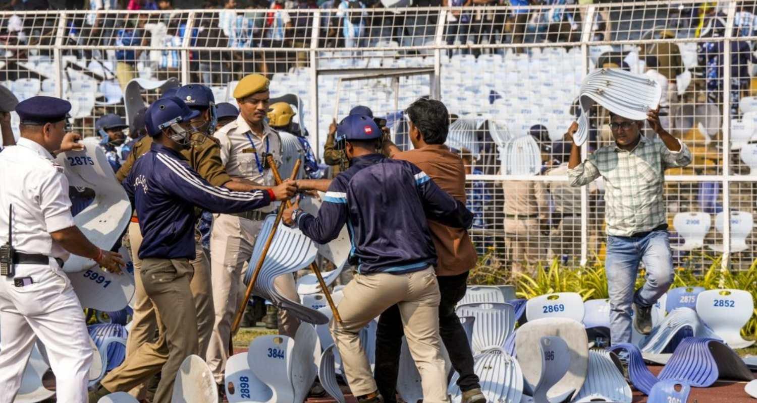 Security personnel try to stop a person amid chaos during an event of Argentine footballer Lionel Messi as part of his 'G.O.A.T. India Tour 2025', at Vivekananda Yuba Bharati Krirangan (VYBK), in Kolkata, Saturday. (File Photo) Security personnel try to stop a person amid chaos during an event of Argentine footballer Lionel Messi as part of his 'G.O.A.T. India Tour 2025', at Vivekananda Yuba Bharati Krirangan (VYBK), in Kolkata, Saturday. (File Photo)