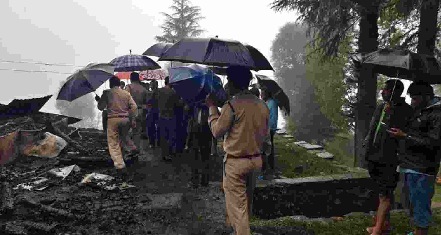 Officials survey the remains of a Forest Department rest house destroyed by fire in the Haban forest range of Sirmaur’s Rajgarh division. Officials survey the remains of a Forest Department rest house destroyed by fire in the Haban forest range of Sirmaur’s Rajgarh division.