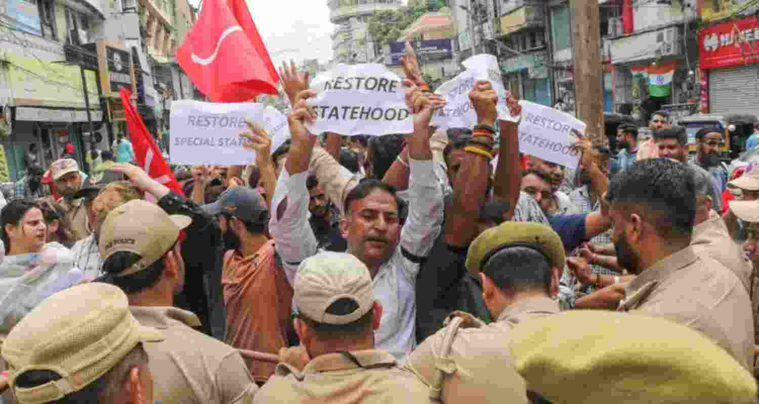 Policemen try to stop Jammu and Kashmir National Conference (JKNC) workers during a protest march demanding restoration of statehood to Jammu and Kashmir. Policemen try to stop Jammu and Kashmir National Conference (JKNC) workers during a protest march demanding restoration of statehood to Jammu and Kashmir.