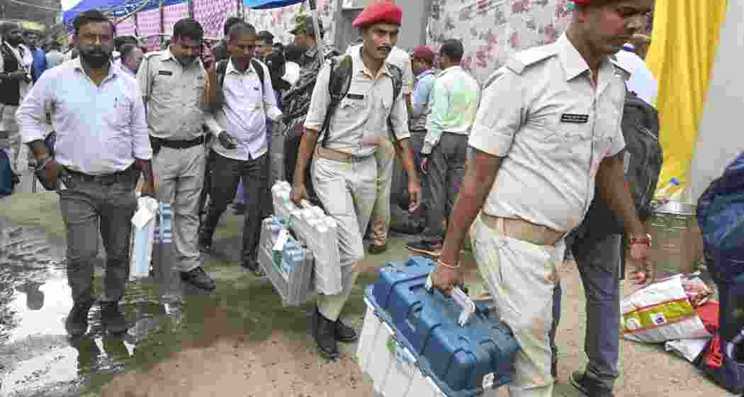 Security personnel with Electronic Voting Machine (EVM) and other election material leave for polling duty. (Image: PTI) Security personnel with Electronic Voting Machine (EVM) and other election material leave for polling duty. (Image: PTI)