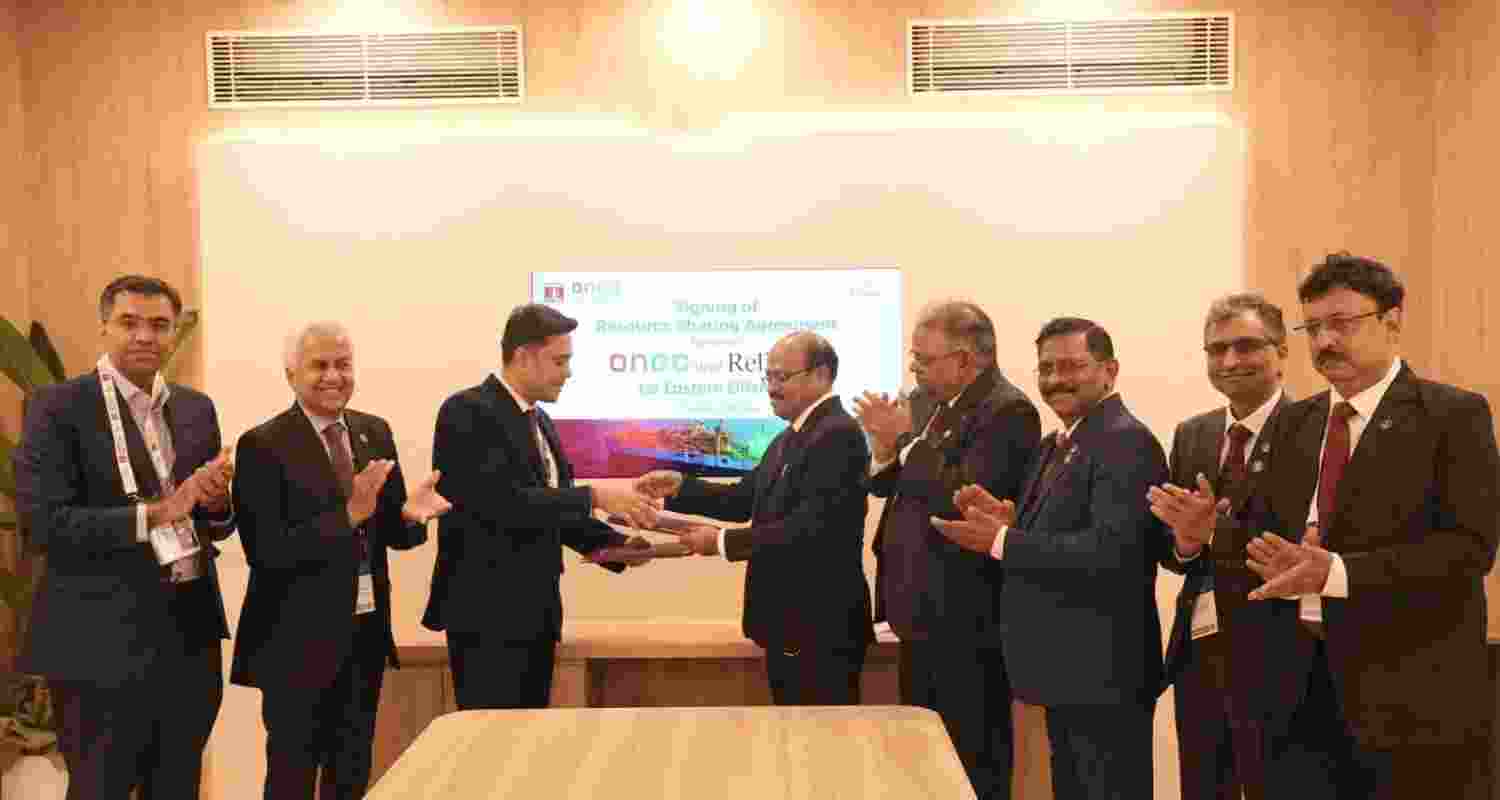 ONGC and Reliance officials after signing the agreement on Wednesday. ONGC and Reliance officials after signing the agreement on Wednesday.