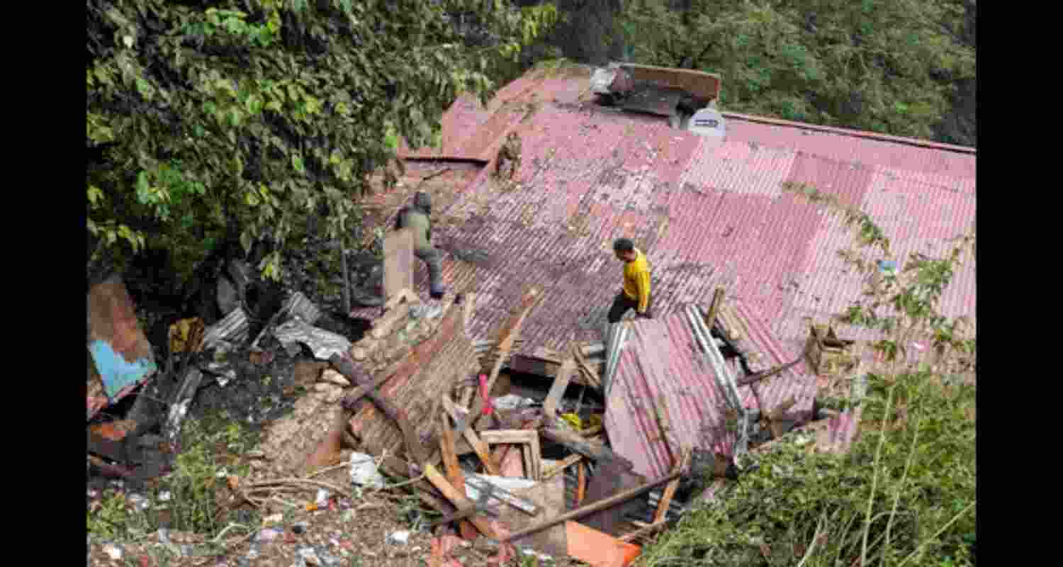 Residents inspect a house, damaged in a landslide following heavy rainfall, in Shimla. Residents inspect a house, damaged in a landslide following heavy rainfall, in Shimla.