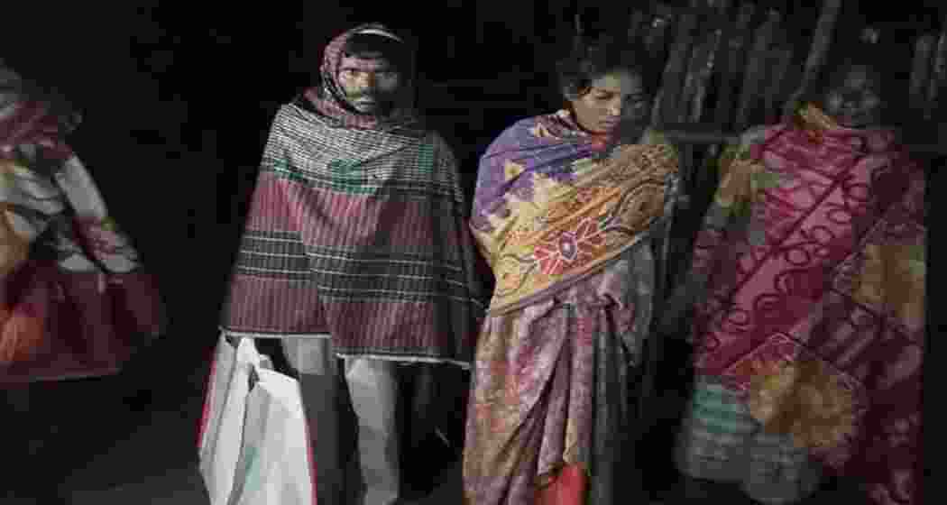 Grieving family members carry the body of a four-month-old infant in a plastic bag outside Chaibasa Sadar Hospital in Jharkhand after alleged delay in arranging transport. Grieving family members carry the body of a four-month-old infant in a plastic bag outside Chaibasa Sadar Hospital in Jharkhand after alleged delay in arranging transport.