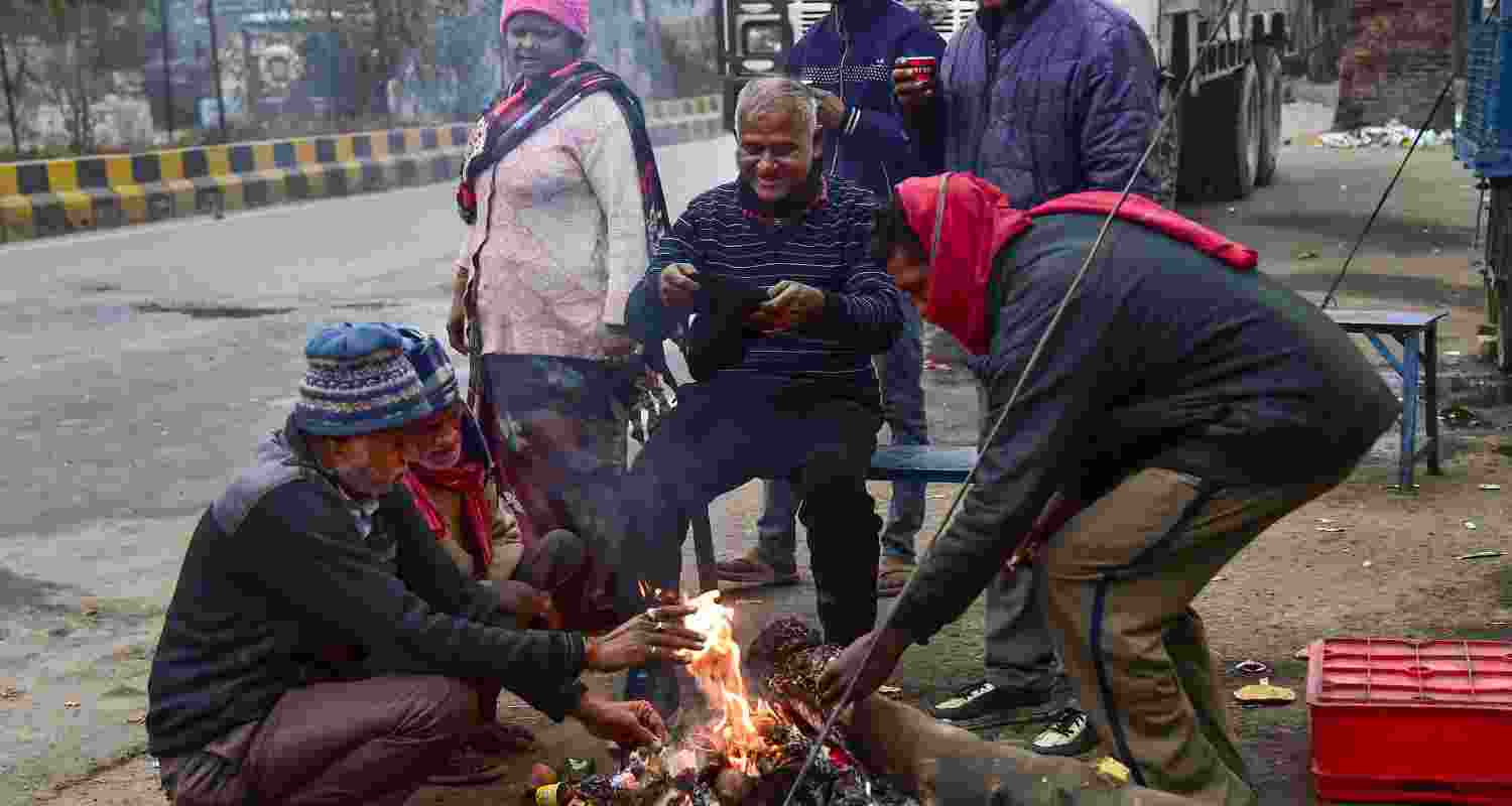 People sit around a bonfire to keep themselves warm on a winter morning, in Prayagraj, Saturday. People sit around a bonfire to keep themselves warm on a winter morning, in Prayagraj, Saturday.