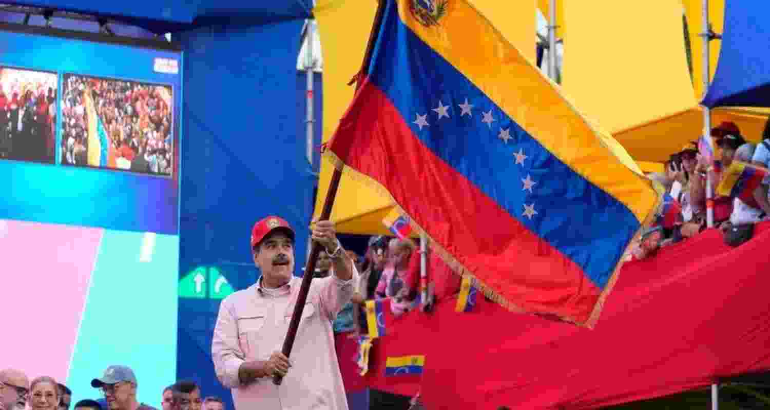 President Nicolas Maduro waves a Venezuelan flag during a swearing-in event for government-organized community committees at the presidential palace in Caracas, Venezuela, Monday. President Nicolas Maduro waves a Venezuelan flag during a swearing-in event for government-organized community committees at the presidential palace in Caracas, Venezuela, Monday.
