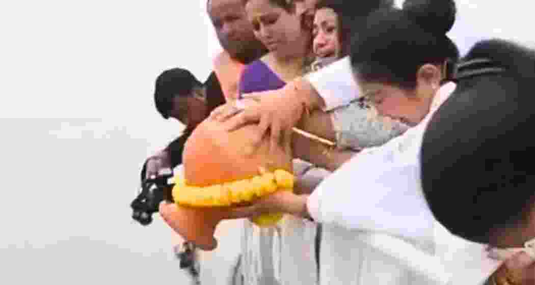 Garima Garg immerses the ashes of her late husband, Zubeen Garg, in the Brahmaputra River.  Garima Garg immerses the ashes of her late husband, Zubeen Garg, in the Brahmaputra River.