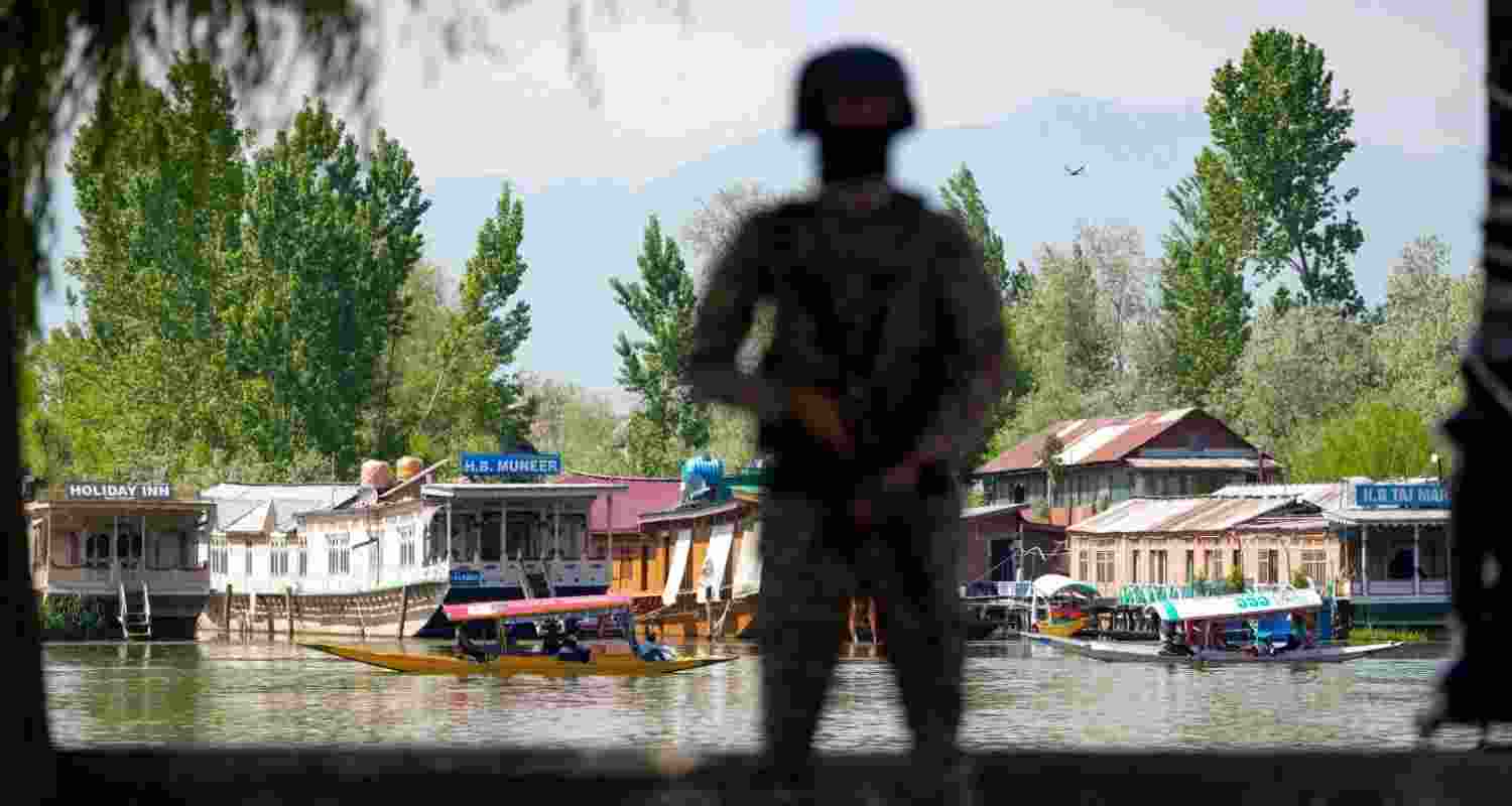 A security official keeps vigil along the Dal Lake area amid heightened security ahead of the Pahalgam attack anniversary, in Srinagar, Tuesday. A security official keeps vigil along the Dal Lake area amid heightened security ahead of the Pahalgam attack anniversary, in Srinagar, Tuesday.