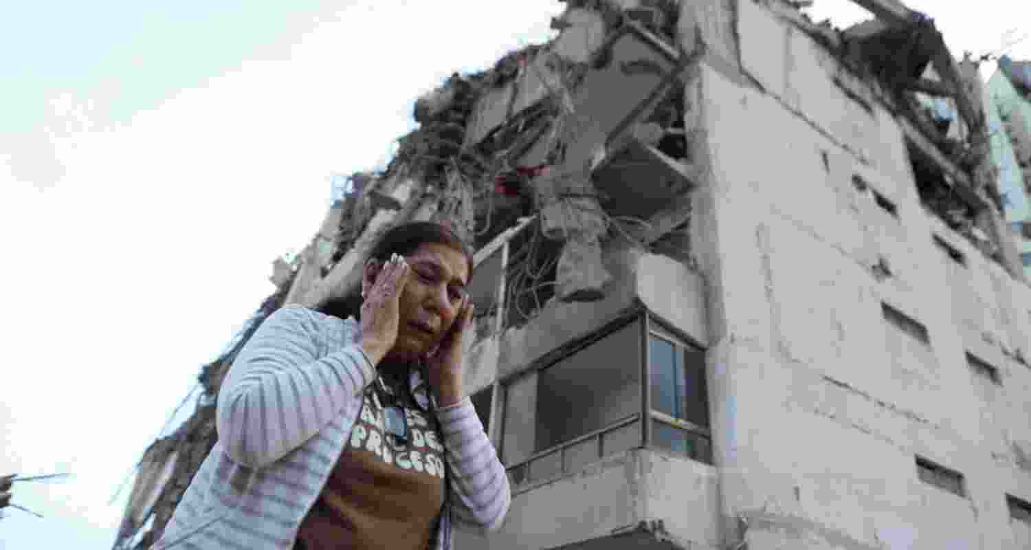 A woman walks past a building damaged during an earthquake in La Guaira, Venezuela. (Photo AP) A woman walks past a building damaged during an earthquake in La Guaira, Venezuela. (Photo AP)