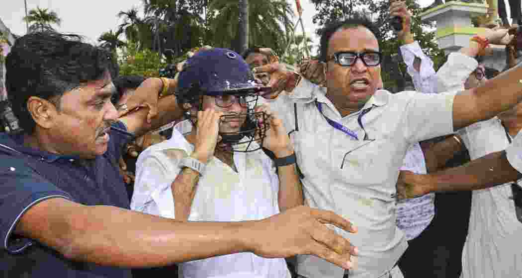 TMC general secretary Abhishek Banerjee wears a helmet after stones, shoes and eggs were hurled at him during his visit to meet families of post-poll violence victims, in Sonarpur, West Bengal on Saturday. (PTI) TMC general secretary Abhishek Banerjee wears a helmet after stones, shoes and eggs were hurled at him during his visit to meet families of post-poll violence victims, in Sonarpur, West Bengal on Saturday. (PTI)