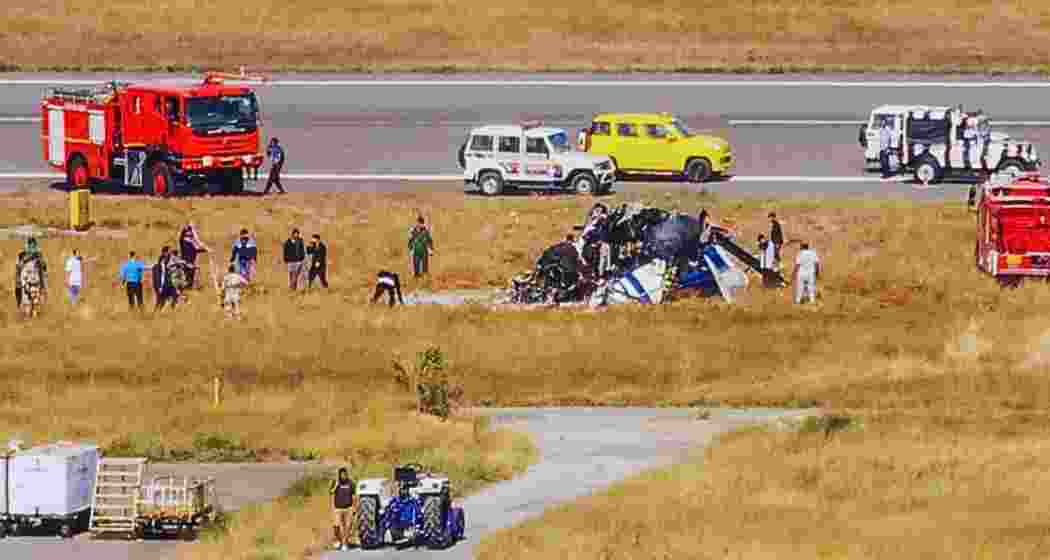 Rescue work underway after a helicopter of the Indian Coast Guard (ICG) crashed during landing at Porbandar airport in Gujarat on Sunday. Three crew members were killed in the incident, according to police. (PTI) Rescue work underway after a helicopter of the Indian Coast Guard (ICG) crashed during landing at Porbandar airport in Gujarat on Sunday. Three crew members were killed in the incident, according to police. (PTI)