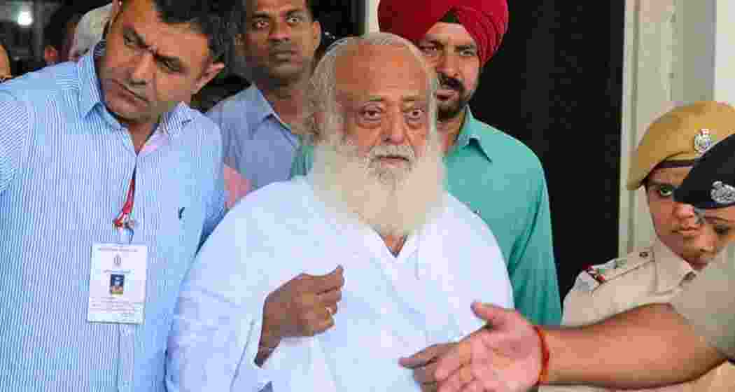 Self-styled godman Asaram Bapu, convicted in two rape cases, comes out of the District Sessions Court, where he was produced after his arrest back in 2021. Self-styled godman Asaram Bapu, convicted in two rape cases, comes out of the District Sessions Court, where he was produced after his arrest back in 2021.