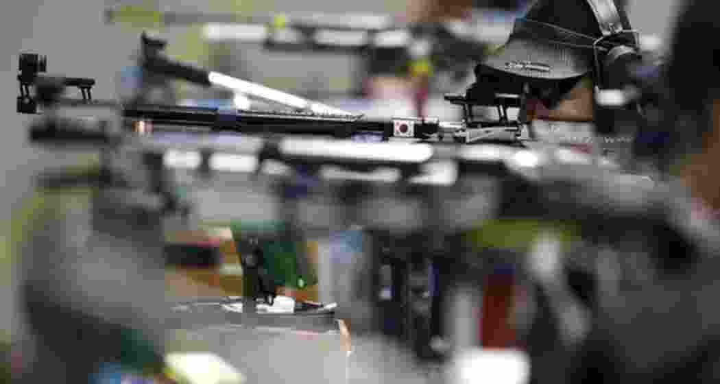 Players lined up, rifles raised, taking aim at targets during the Asian Shooting Championship Players lined up, rifles raised, taking aim at targets during the Asian Shooting Championship