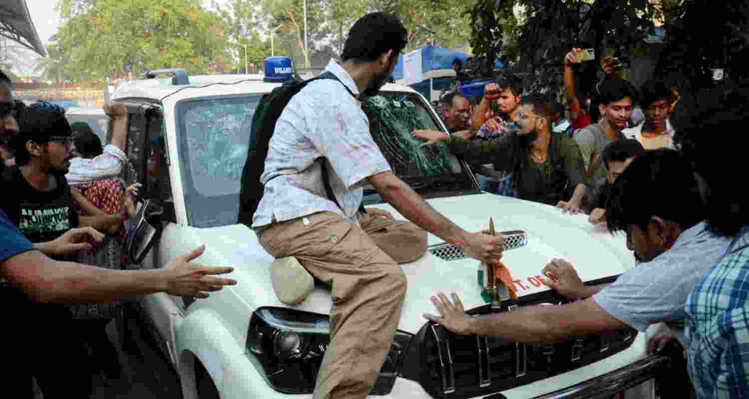 Students’ Federation of India (SFI) members gather around West Bengal Education Minister Bratya Basu’s car at Jadavpur University campus, in Kolkata. Students’ Federation of India (SFI) members gather around West Bengal Education Minister Bratya Basu’s car at Jadavpur University campus, in Kolkata.