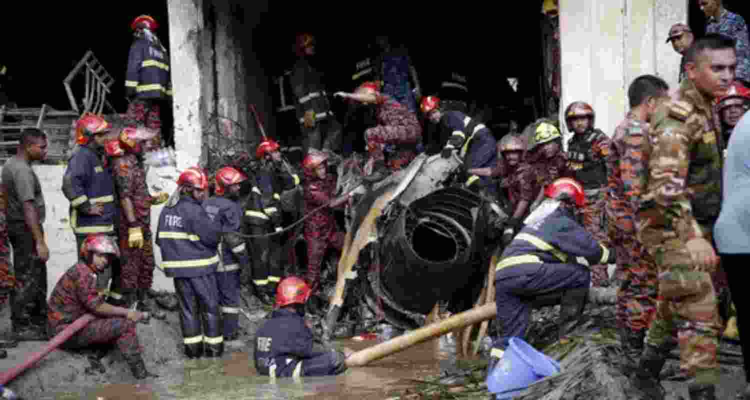Firefighters work to remove the wreckage from a building, after an air force training aircraft crashed into Milestone College campus, in Dhaka, Bangladesh. Firefighters work to remove the wreckage from a building, after an air force training aircraft crashed into Milestone College campus, in Dhaka, Bangladesh.