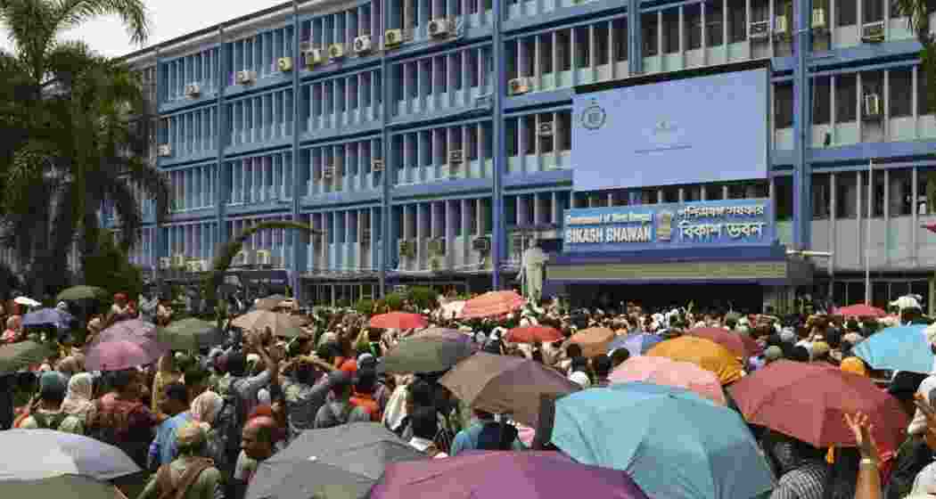 School teachers, who have been rendered jobless by a Supreme Court order, stage a protest demanding restoration of their jobs, in front of the office of the state education minister in Kolkata. School teachers, who have been rendered jobless by a Supreme Court order, stage a protest demanding restoration of their jobs, in front of the office of the state education minister in Kolkata.