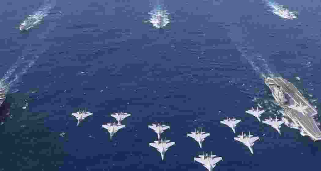 A fleet of Chinese aircraft, carriers, and naval vessels conducts military drills near Taiwan, escalating regional tensions amid Beijing's show of force. (Representational image) A fleet of Chinese aircraft, carriers, and naval vessels conducts military drills near Taiwan, escalating regional tensions amid Beijing's show of force. (Representational image)