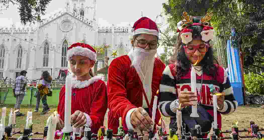 Devotees light candles during Christmas celebrations at a church, in Kolkata, West Bengal on Wednesday, Dec. 25, 2024. Devotees light candles during Christmas celebrations at a church, in Kolkata, West Bengal on Wednesday, Dec. 25, 2024.