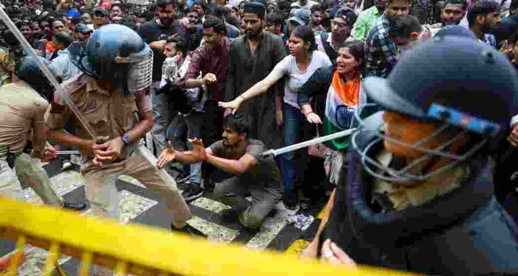 Police personnel confront CJP supporters during a protest near a barricade in New Delhi. Police personnel confront CJP supporters during a protest near a barricade in New Delhi.