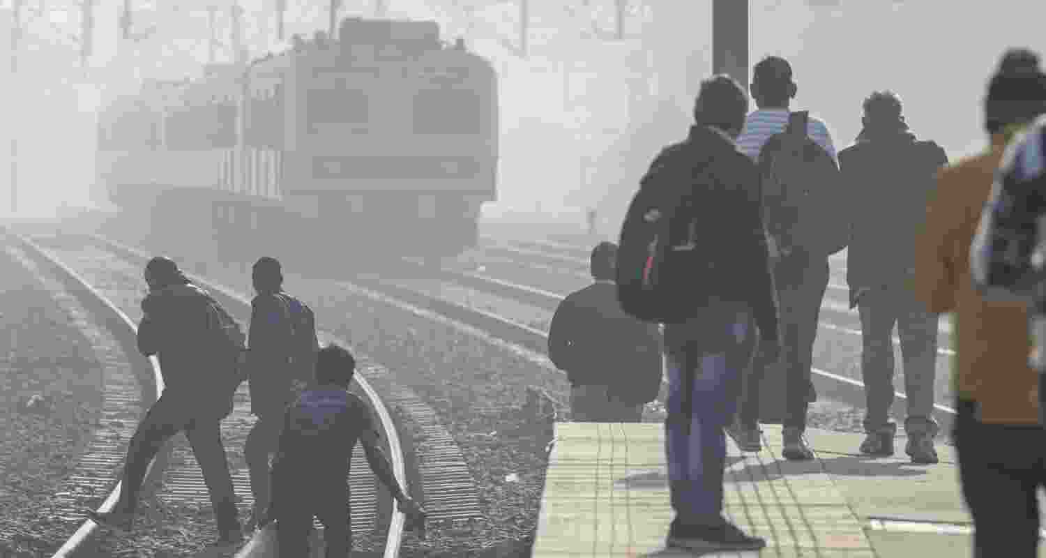 People wait at a railway platform in New Delhi. People wait at a railway platform in New Delhi.