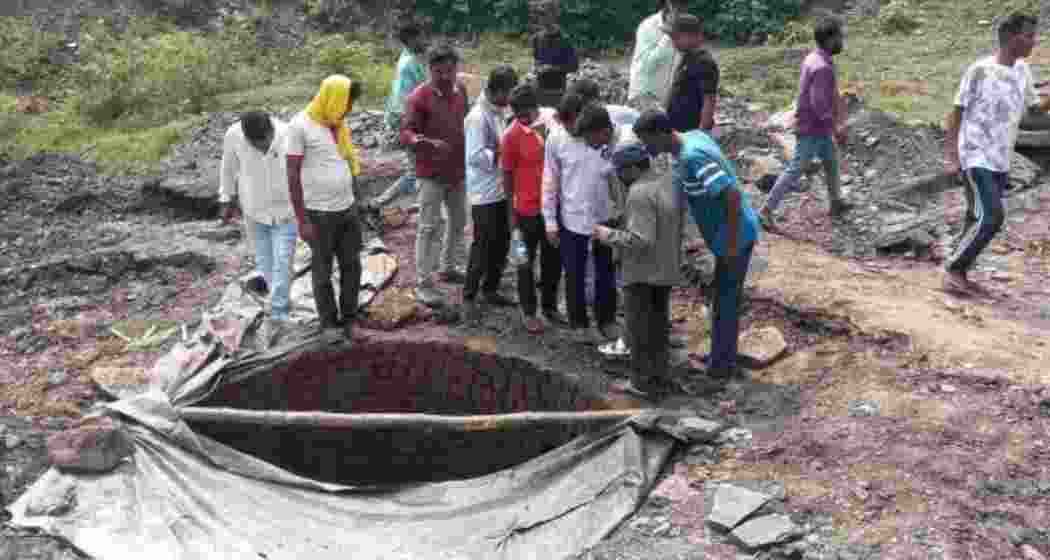 Locals gather at the spot after a portion of a coal mine collapsed on Wednesday in Jharkhand's Dhanbad district. Locals gather at the spot after a portion of a coal mine collapsed on Wednesday in Jharkhand's Dhanbad district.