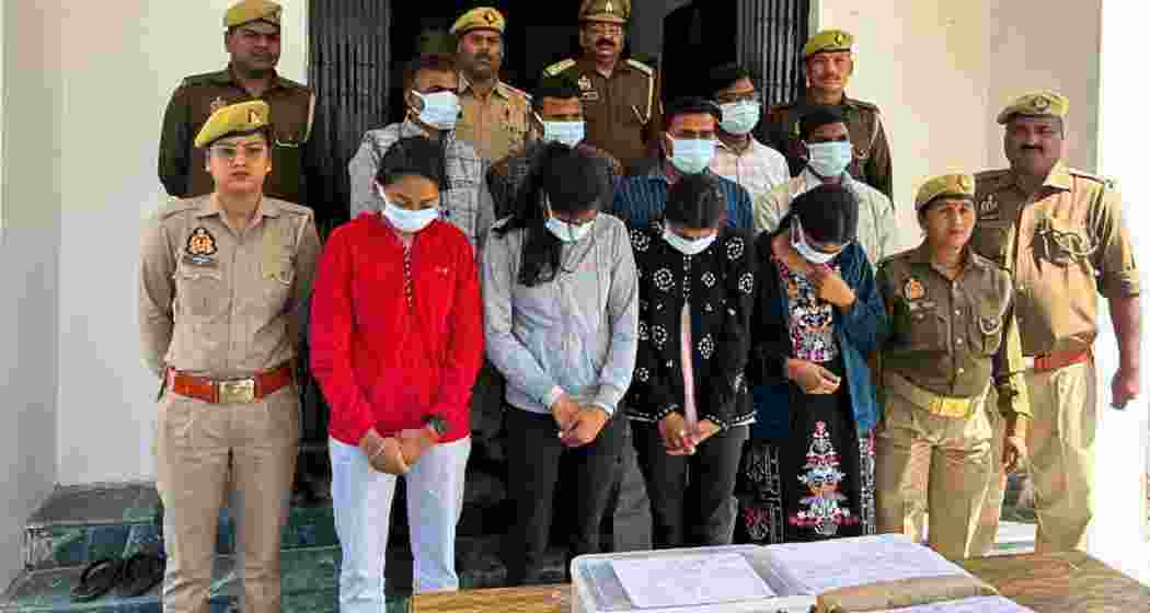 Security personnel with the solver gang involved in the UP Board exams after their arrest. A total of 16 individuals were apprehended for unlawfully solving question papers. Security personnel with the solver gang involved in the UP Board exams after their arrest. A total of 16 individuals were apprehended for unlawfully solving question papers.
