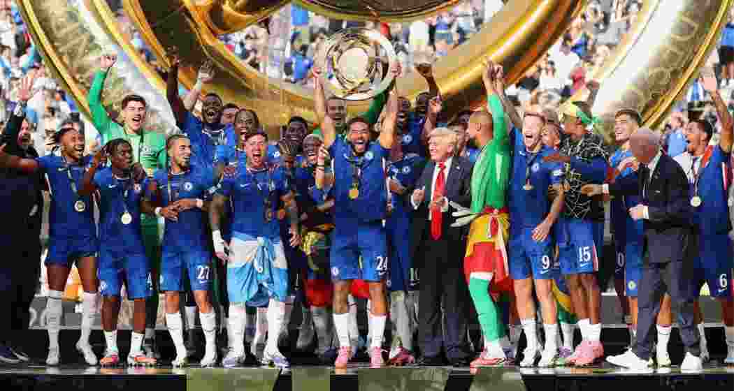 Chelsea players celebrate with the Club World Cup trophy after defeating PSG 3-0 in New Jersey on Sunday, 13 July 2025. President Donald Trump joins them on the podium. Chelsea players celebrate with the Club World Cup trophy after defeating PSG 3-0 in New Jersey on Sunday, 13 July 2025. President Donald Trump joins them on the podium.