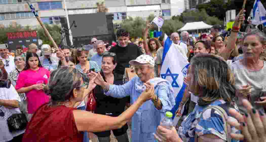 People react as they gather to watch a live broadcast of Israeli hostages released from Gaza at a plaza known as hostages square in Tel Aviv, Israel, Monday. People react as they gather to watch a live broadcast of Israeli hostages released from Gaza at a plaza known as hostages square in Tel Aviv, Israel, Monday.