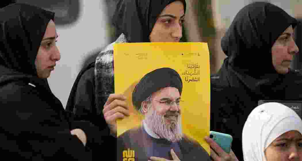 A Lebanese woman holds a portrait of slain Hezbollah leader Sayyed Hassan Nasrallah while waiting with others for permission from the Lebanese army to enter their village, following the Israeli troop withdrawal in Bint Jbeil, southern Lebanon, on 26 January 2025. A Lebanese woman holds a portrait of slain Hezbollah leader Sayyed Hassan Nasrallah while waiting with others for permission from the Lebanese army to enter their village, following the Israeli troop withdrawal in Bint Jbeil, southern Lebanon, on 26 January 2025.
