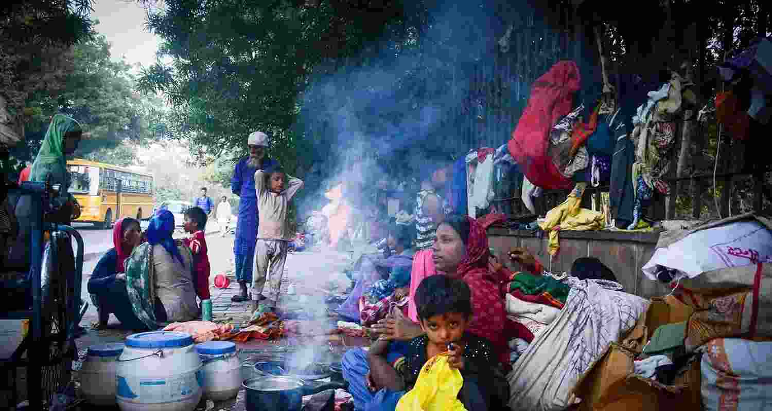 Homeless people set up temporary lodgings on a street in New Delhi. Homeless people set up temporary lodgings on a street in New Delhi.