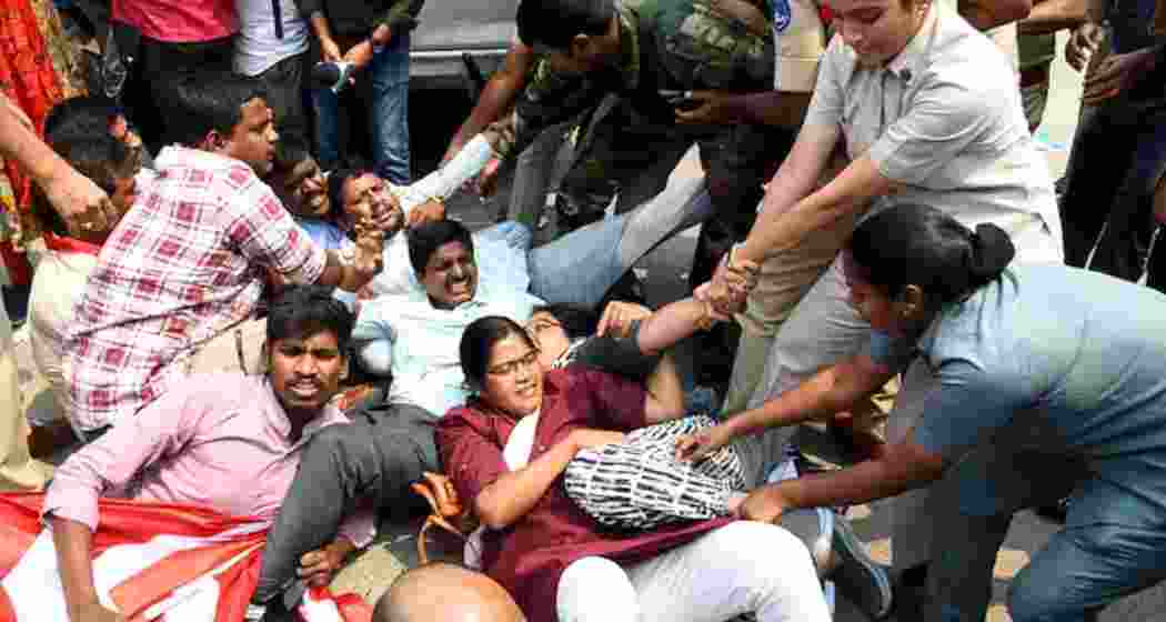 Police personnel stop University of Hyderabad students and faculty members in Hyderabad on Wednesday as they protest the Telangana government’s plan to develop 400 acres of land near the varsity. Police personnel stop University of Hyderabad students and faculty members in Hyderabad on Wednesday as they protest the Telangana government’s plan to develop 400 acres of land near the varsity.