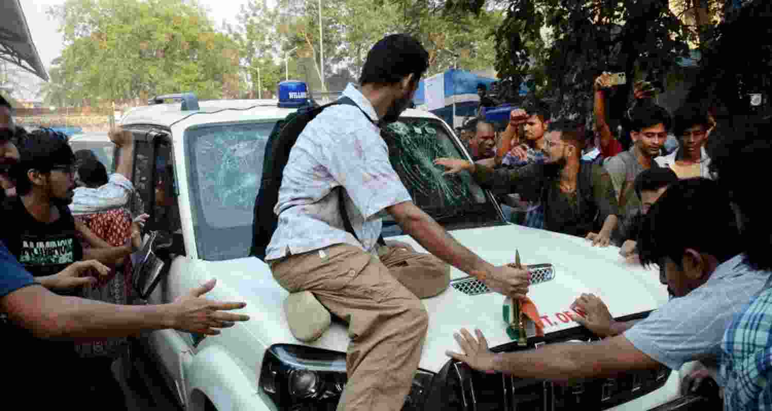 SFI members gathered around West Bengal Education Minister Bratya Basu’s car at Jadavpur University campus, in Kolkata, on March 1. File photo. SFI members gathered around West Bengal Education Minister Bratya Basu’s car at Jadavpur University campus, in Kolkata, on March 1. File photo.