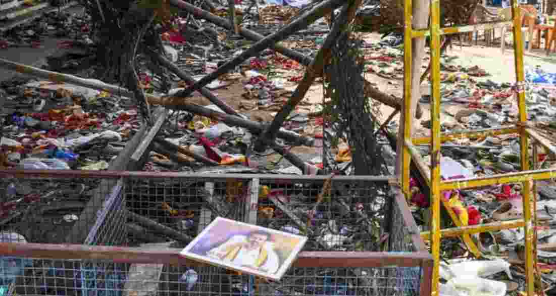A portrait of Vijay lies on a metal fencing after the stampede. A portrait of Vijay lies on a metal fencing after the stampede.