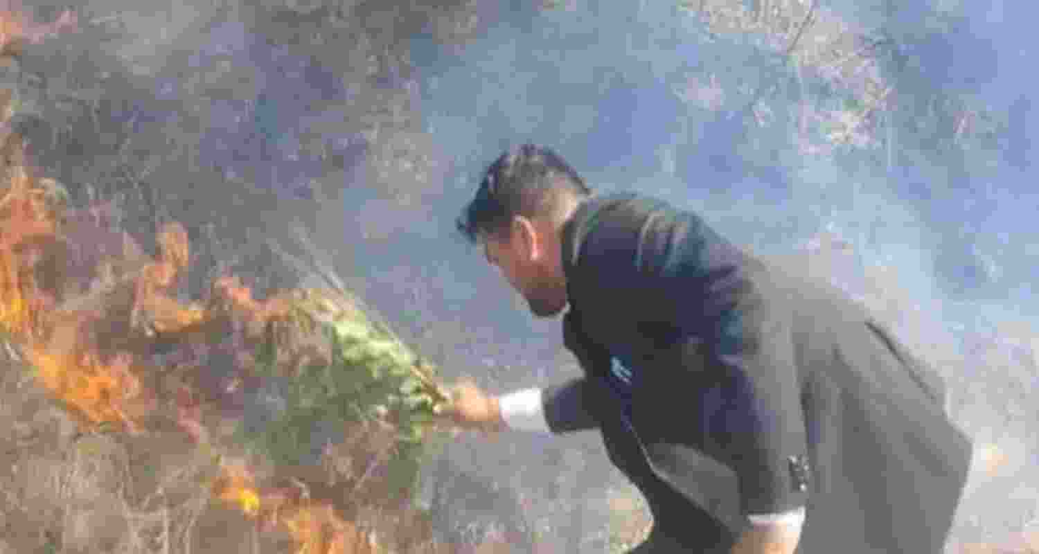 Local residents attempt to douse the forest fire as it spreads across the area in Uttarakhand. Local residents attempt to douse the forest fire as it spreads across the area in Uttarakhand.