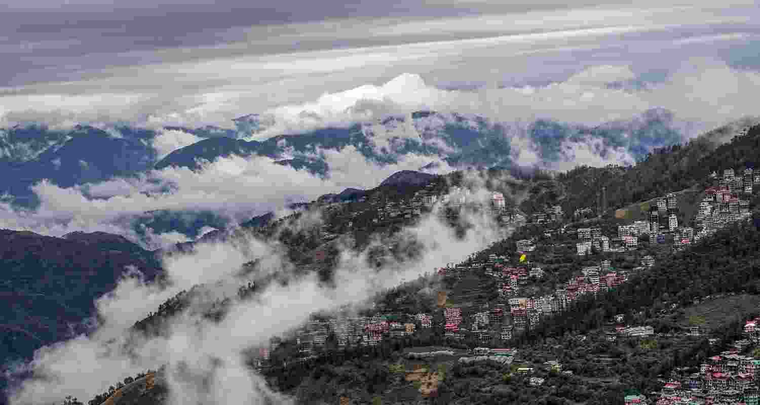 Low clouds cover a hill town during rainfall, in Shimla, Wednesday. Low clouds cover a hill town during rainfall, in Shimla, Wednesday.