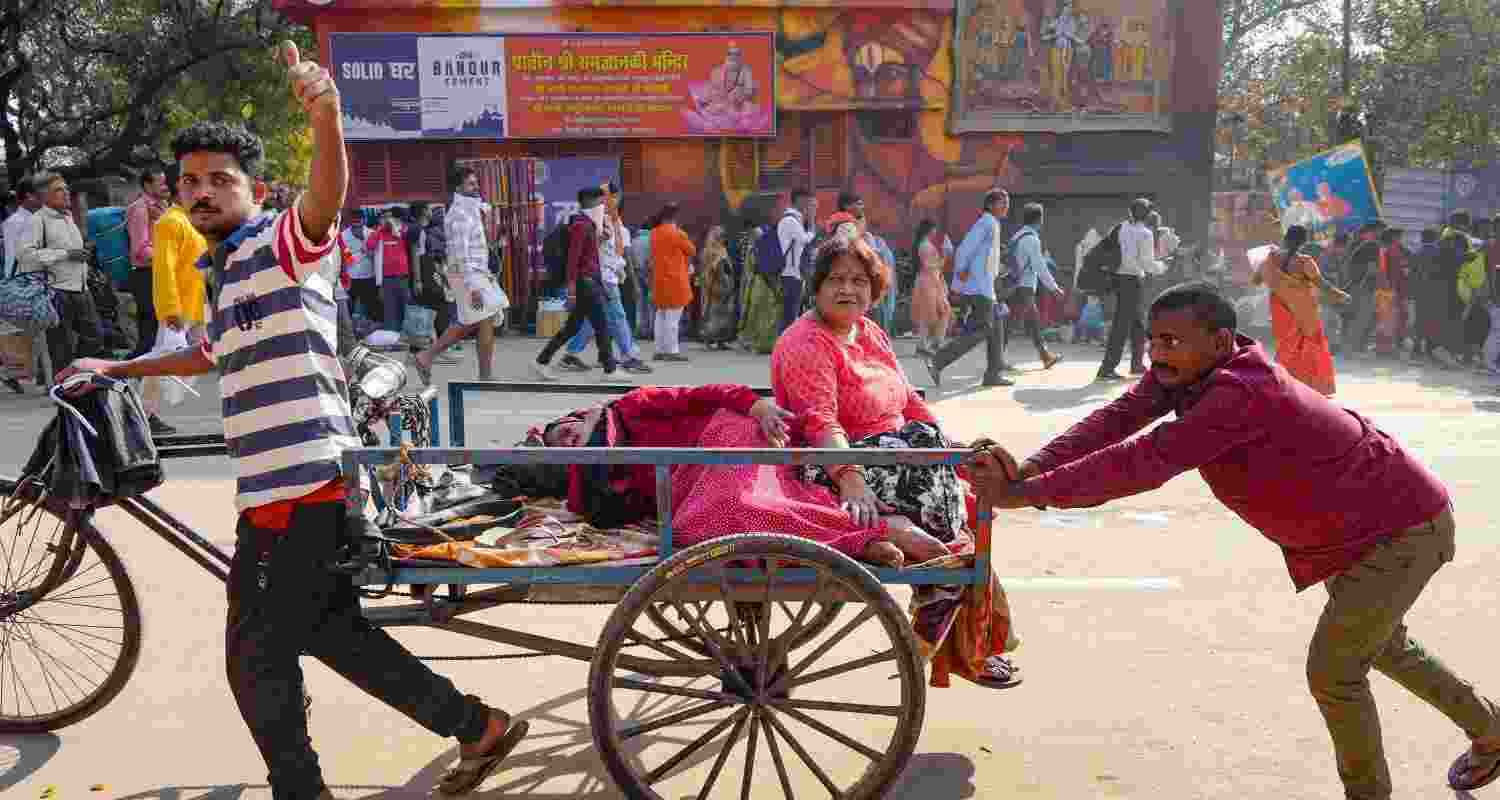 Devotees ride a rear loading cycle rickshaw during the ongoing Mahakumbh Mela, in Prayagraj, Uttar Pradesh, Tuesday. Devotees ride a rear loading cycle rickshaw during the ongoing Mahakumbh Mela, in Prayagraj, Uttar Pradesh, Tuesday.