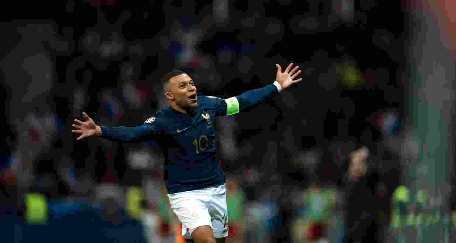 Kylian Mbape dressed in PSG jersey celebrating a goal. Kylian Mbape dressed in PSG jersey celebrating a goal.