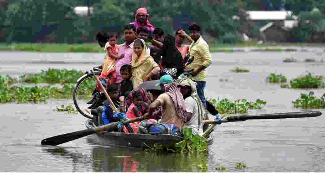 Residents of Katahguri village along the Brahmaputra, east of Guwahati, relocate to safer areas amid severe flooding in Assam. Residents of Katahguri village along the Brahmaputra, east of Guwahati, relocate to safer areas amid severe flooding in Assam.