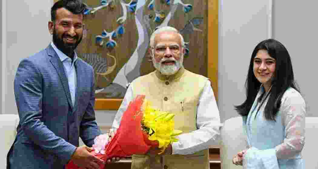 Cheteshwar Pujara (L) and his wife Puja (R) with PM Narendra Modi. Cheteshwar Pujara (L) and his wife Puja (R) with PM Narendra Modi.