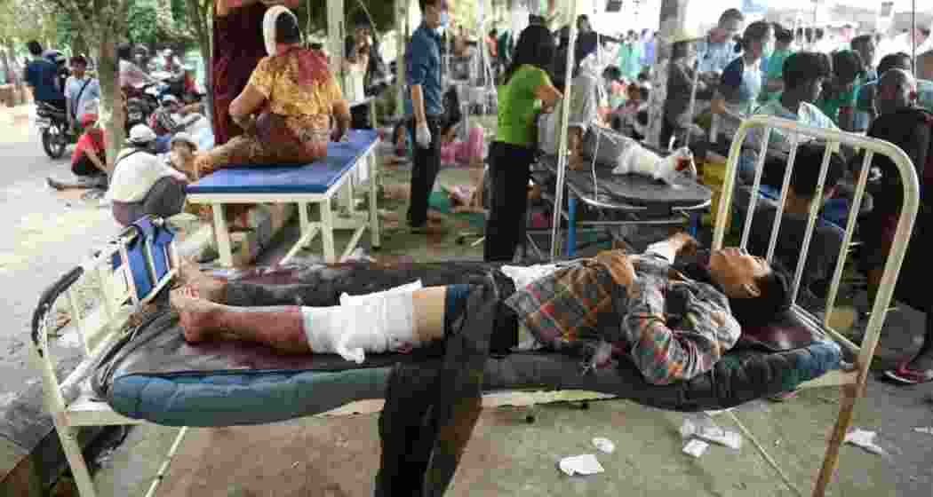 Injured survivors receive medical aid at a temporary shelter after a powerful earthquake struck Myanmar on Friday, claiming at least 694 lives. Tremors were felt in India, Bangladesh, and China. Injured survivors receive medical aid at a temporary shelter after a powerful earthquake struck Myanmar on Friday, claiming at least 694 lives. Tremors were felt in India, Bangladesh, and China.