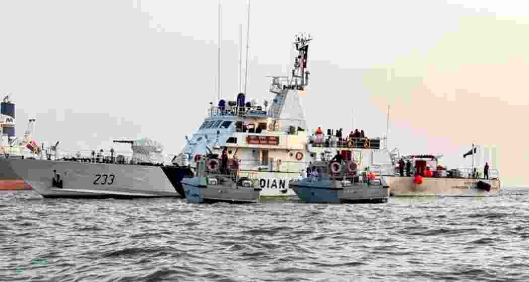Navy and Coast Guard vessels engage in search and rescue operations near the site of the ferry-Navy craft collision off the Mumbai coast on Thursday. Navy and Coast Guard vessels engage in search and rescue operations near the site of the ferry-Navy craft collision off the Mumbai coast on Thursday.