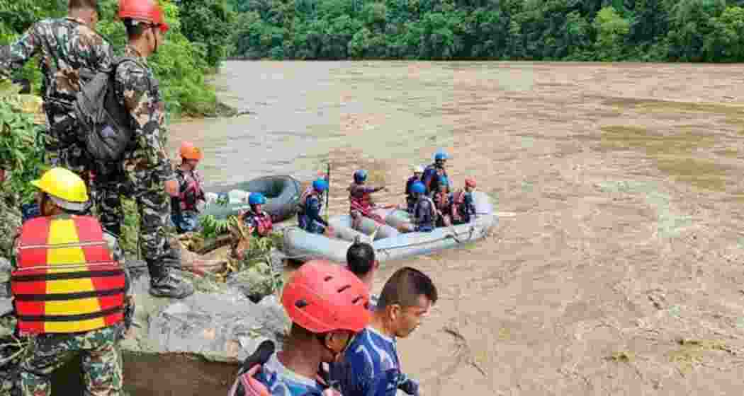 Rescue workers search for survivors after two buses were swept off the highway into the swollen Trishuli River near Simaltal, Nepal. Rescue workers search for survivors after two buses were swept off the highway into the swollen Trishuli River near Simaltal, Nepal.