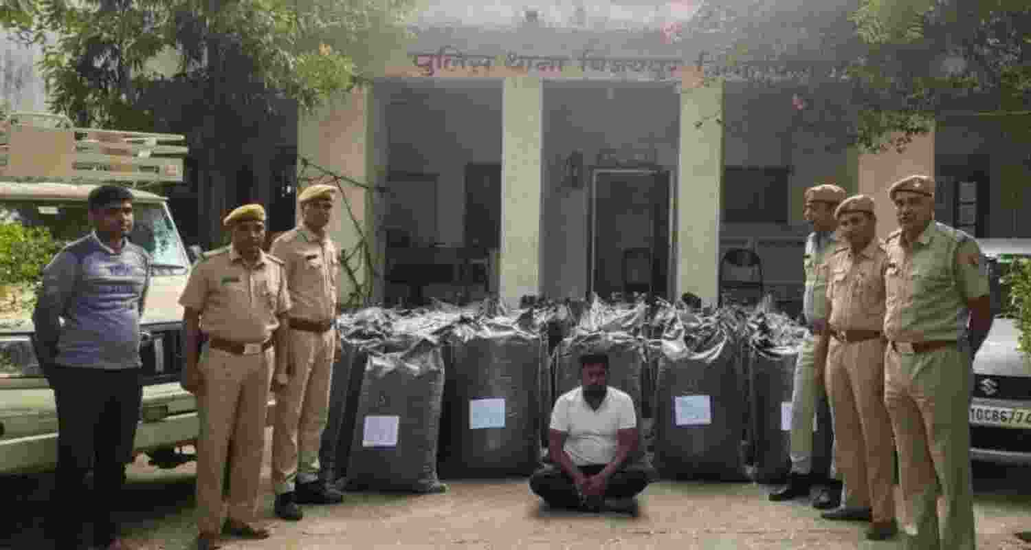 Image of the Confiscated Opium Poppy Powder and the smuggler who was caught, shared by Chittorgarh police on X. Image of the Confiscated Opium Poppy Powder and the smuggler who was caught, shared by Chittorgarh police on X.